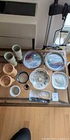 Overview of all ceramic and stoneware pieces on table