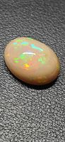 Oblique view of oval opal showing multicolor play-of-color