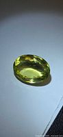 Top view of faceted lemon citrine showcasing oval shape and color