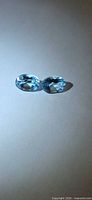Front view of both oval sky blue topaz stones