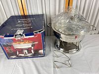 Chafing dish assembled beside original box and tongs