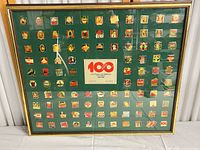 Overall view of framed Coca-Cola Centennial pin set