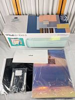 Boxed Cricut Explore 3 with starter kit sheets and tools displayed
