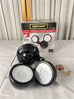 Boxed Defiant security light with two LED heads, sensor base, connectors visible