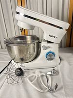 Mixer with bowl and attachments displayed