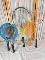 Group shot showing all five rackets/paddles