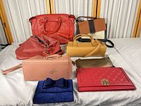 All eight bags and wallets arranged on table