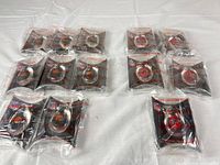 All twelve packaged Lucky Cheering Stones displayed on table, showing multiple team logos