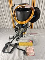 Sprayer unit with hopper, coiled hose, spray gun, roller, tips packet