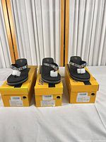 Three boxed pairs of flip flops displayed