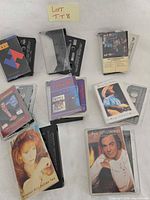 Group shot of all nine cassette tapes with cases, titles visible