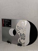 Front view of silver die-cut sleeve with vinyl partly exposed