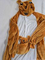 Full view of kangaroo onesie front showing hood, pouch, button closure