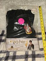 Front of packaged costume showing robe crest and size label