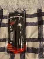 Front view of sealed Benchmark 14-in-1 ratcheting screwdriver package