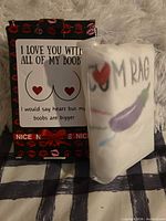 Front view of boxed towel showing humorous box text and packaged towel with “CUM RAG” print