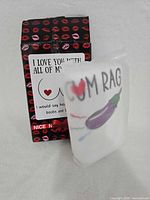 Towel partially unwrapped beside retail box showing graphics and text