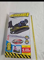 Front of sealed box showing Sportsstuff Descender sled image and branding