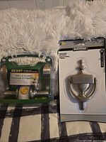 Both packaged items: lever set and door knocker