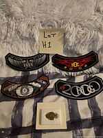 All four patches and lapel pin arranged for overview