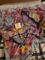 Full view of scarf showing main cat-butterfly motif and pom-pom trim