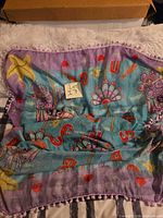 Full view of large Irregular Choice carousel horse scarf laid flat