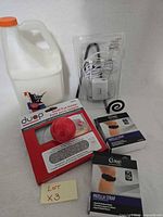 All items together showing glue jug, Duop pad holder, Lemax adapter package, two Curad strap boxes