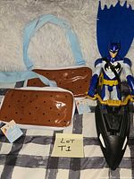 Overall lot showing two fanny packs, action figure, jet ski