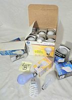 All items overview with GE 12-pack box open, other boxed bulbs and loose bulbs