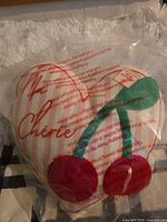 Front of packaged heart pillow showing design and unopened condition