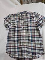 Front view of plaid short-sleeve dress shirt showing overall design