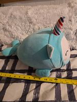 Side profile showing overall shape, tail, horn and tape for length