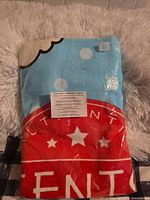 Front view of sealed Scentsy towel showing colors and logo