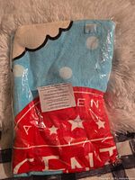 Front view of sealed Scentsy towel showing blue cloud and red star design