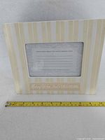 Front of Hallmark porcelain frame with measuring tape showing overall width