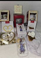 Group shot of all six boxed Hallmark ornaments and loose blister figure