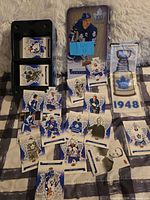 Overview of tin, loose Centennial cards and sealed 1948 banner