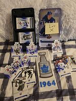 Overall lot showing collector tin, loose die-cut and base cards, and 1964 banner