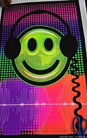 Full view of poster design showing smiley face with headphones and waveform