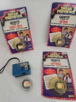 Set showing three sealed cassette packages, blue viewer, loose reel