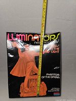 Front of sealed model kit box with tape measure, showing branding and artwork