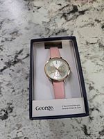 Watch in original box showing dial, strap, and branding