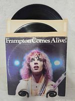 Front of Frampton Comes Alive! jacket with vinyl records visible