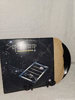Front of Supertramp Crime of the Century LP with record partially out of sleeve
