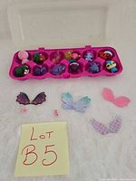 Overview of case with figures, wings and connectors on white surface