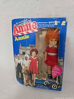 Front of original Annie doll box showing doll and locket