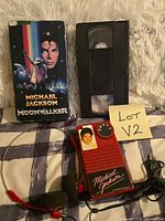 VHS sleeve, cassette tape, red cassette player, headphones overview