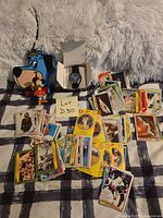 All items laid out: Huckleberry Hound radio, Minnie Mouse figure, Superman watch in box, scattered trading cards