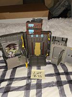 Front view of fully opened three-panel playset with Joker figure displayed