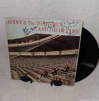 Front album cover with autographs and vinyl partially visible